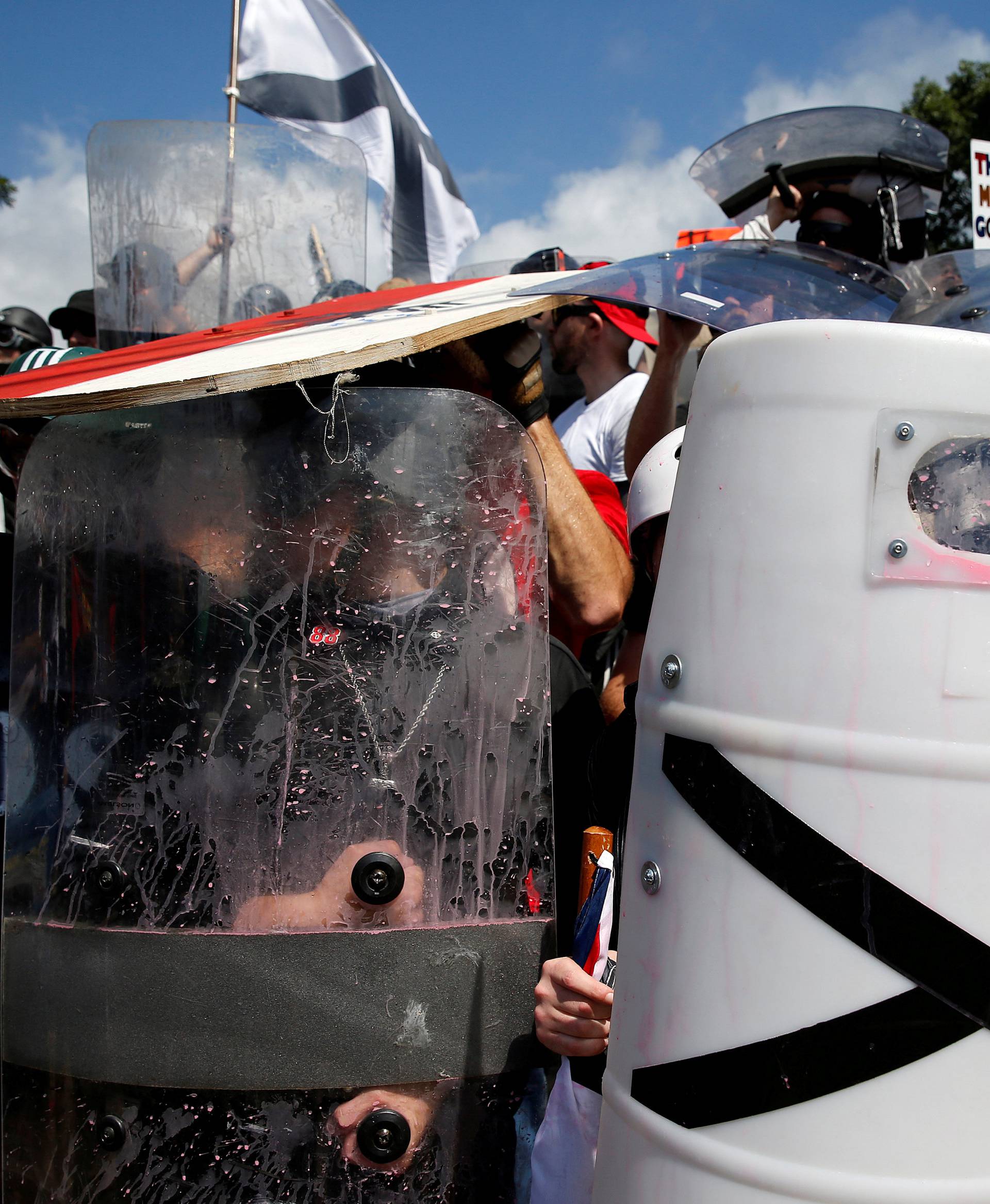 White supremacists shelter behind their shields after clashing with counter protesters at a rally in Charlottesville, Virginia