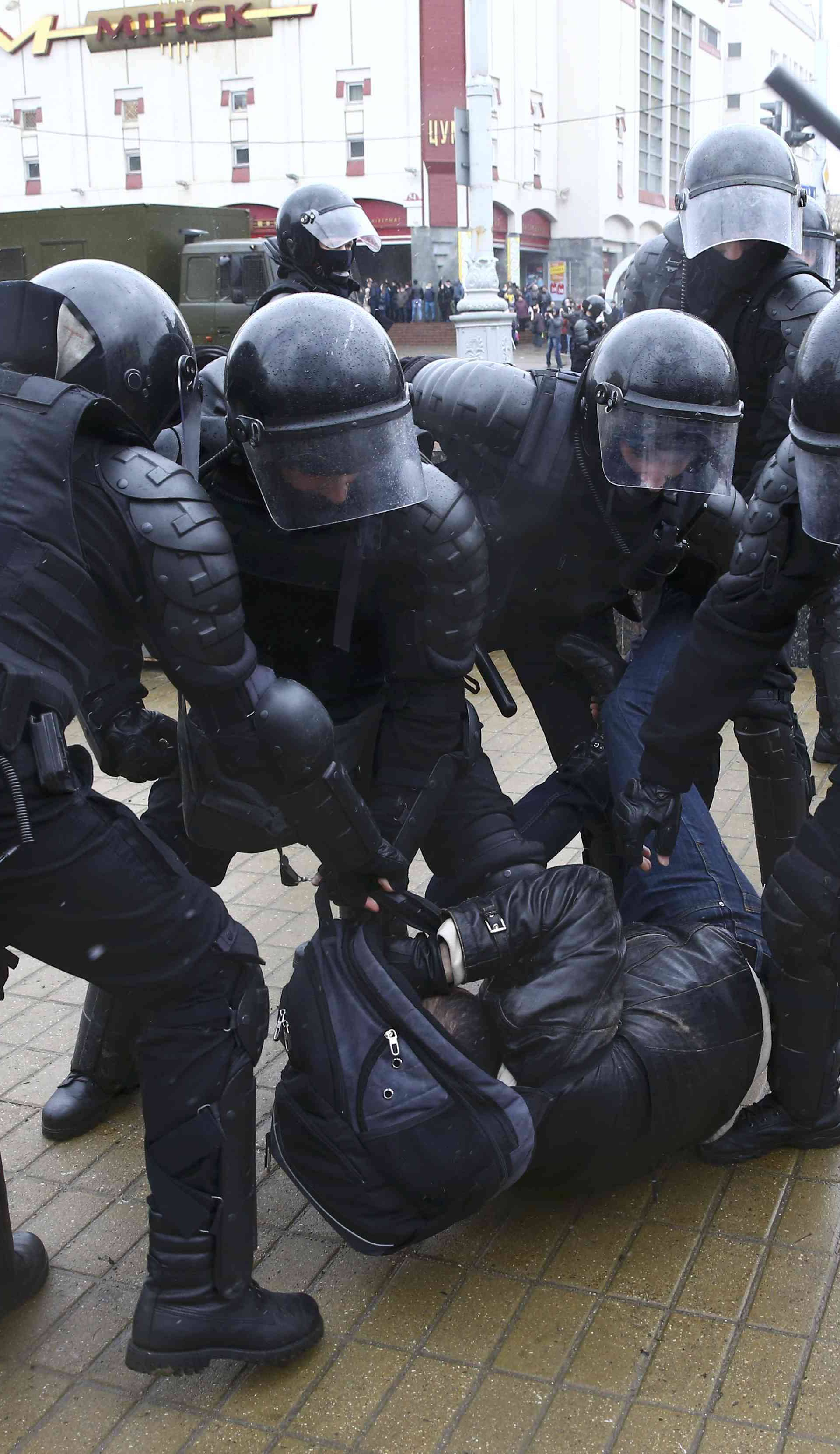 Law enforcement officers detain a participant of a rally marking the anniversary of the proclamation of the Belarussian People's Republic in Minsk