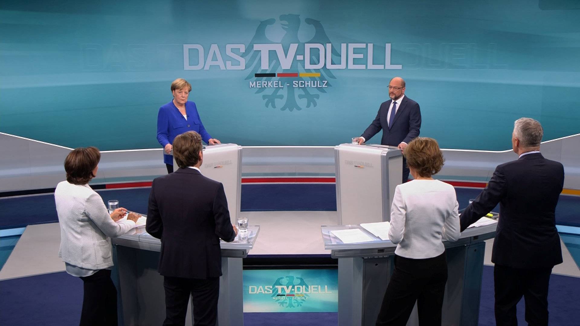 A screen that shows the TV debate between German Chancellor Angela Merkel of the Christian Democratic Union (CDU) and her challenger Germany's Social Democratic Party SPD candidate for chancellor Martin Schulz in Berlin