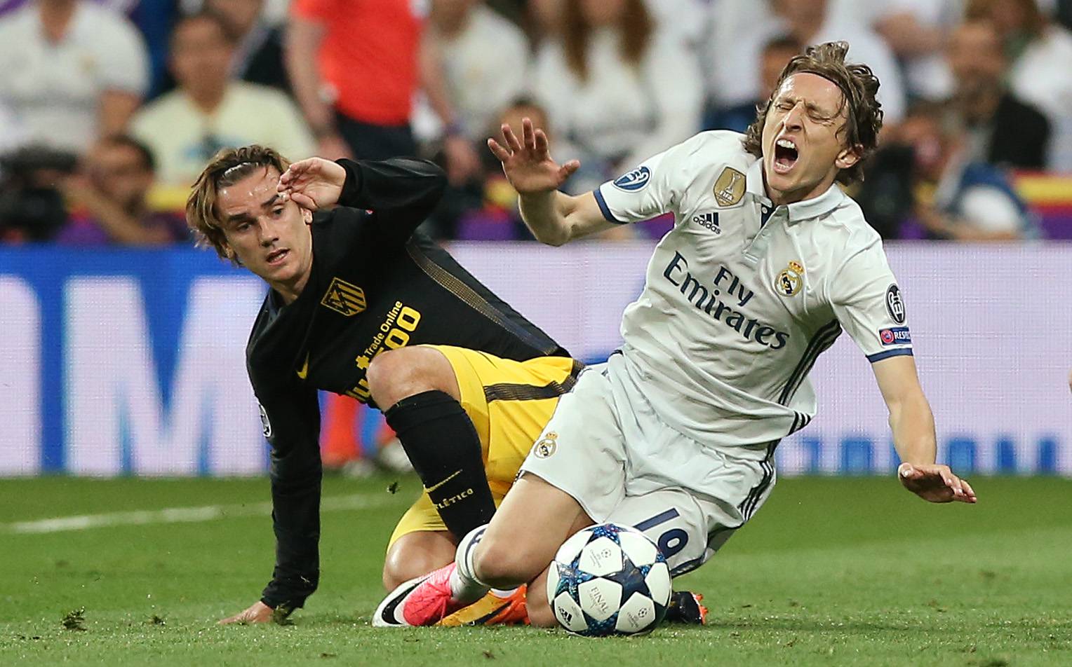 Real Madrid's Luka Modric in action with Atletico Madrid's Antoine Griezmann