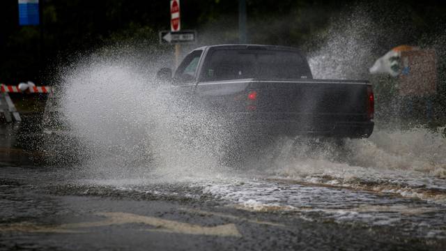 A man drives his vehicle around the Union Point Park Complex through floodwaters as the Hurricane Florence comes ashore in New Bern, North Carolina