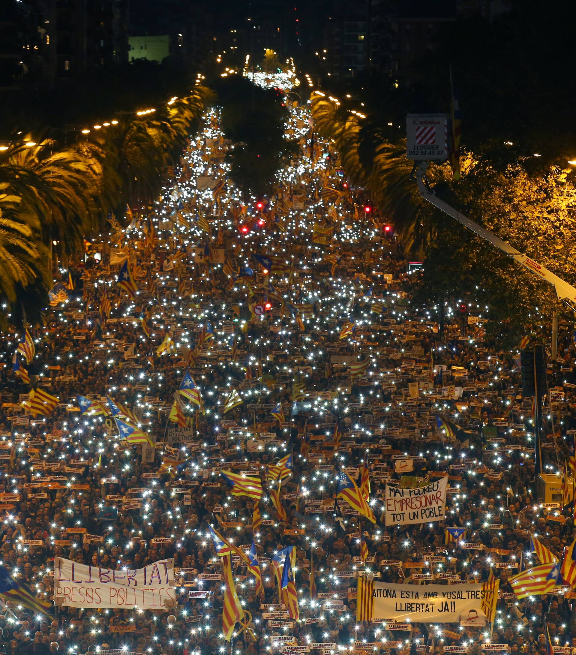 Protestors hold the light of their mobiles during a demonstration called by pro-independence associations asking for the release of jailed Catalan activists and leaders in Barcelona
