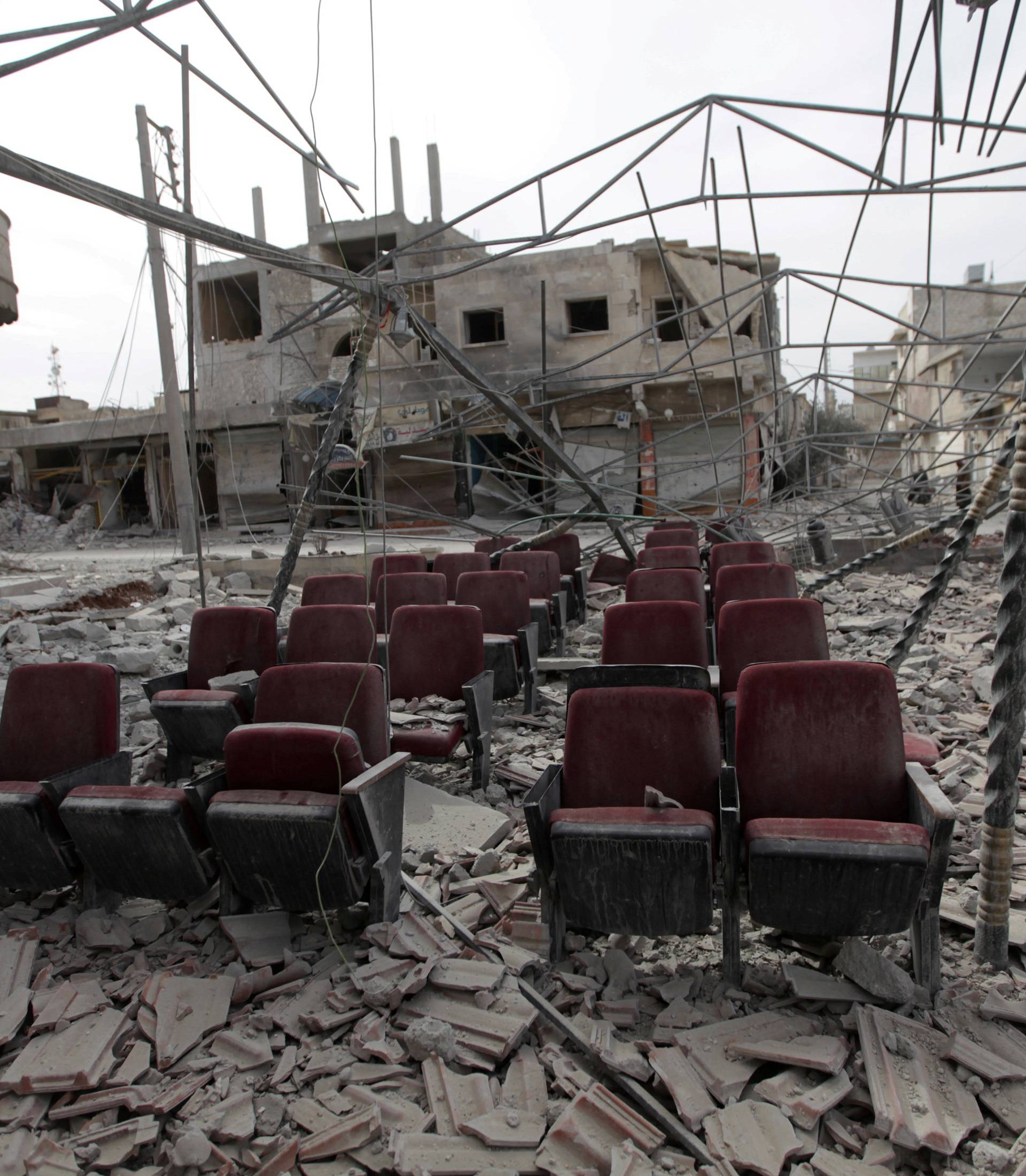 Damaged seats are pictured amidst rubble of buildings in the northern Syrian town of al-Bab