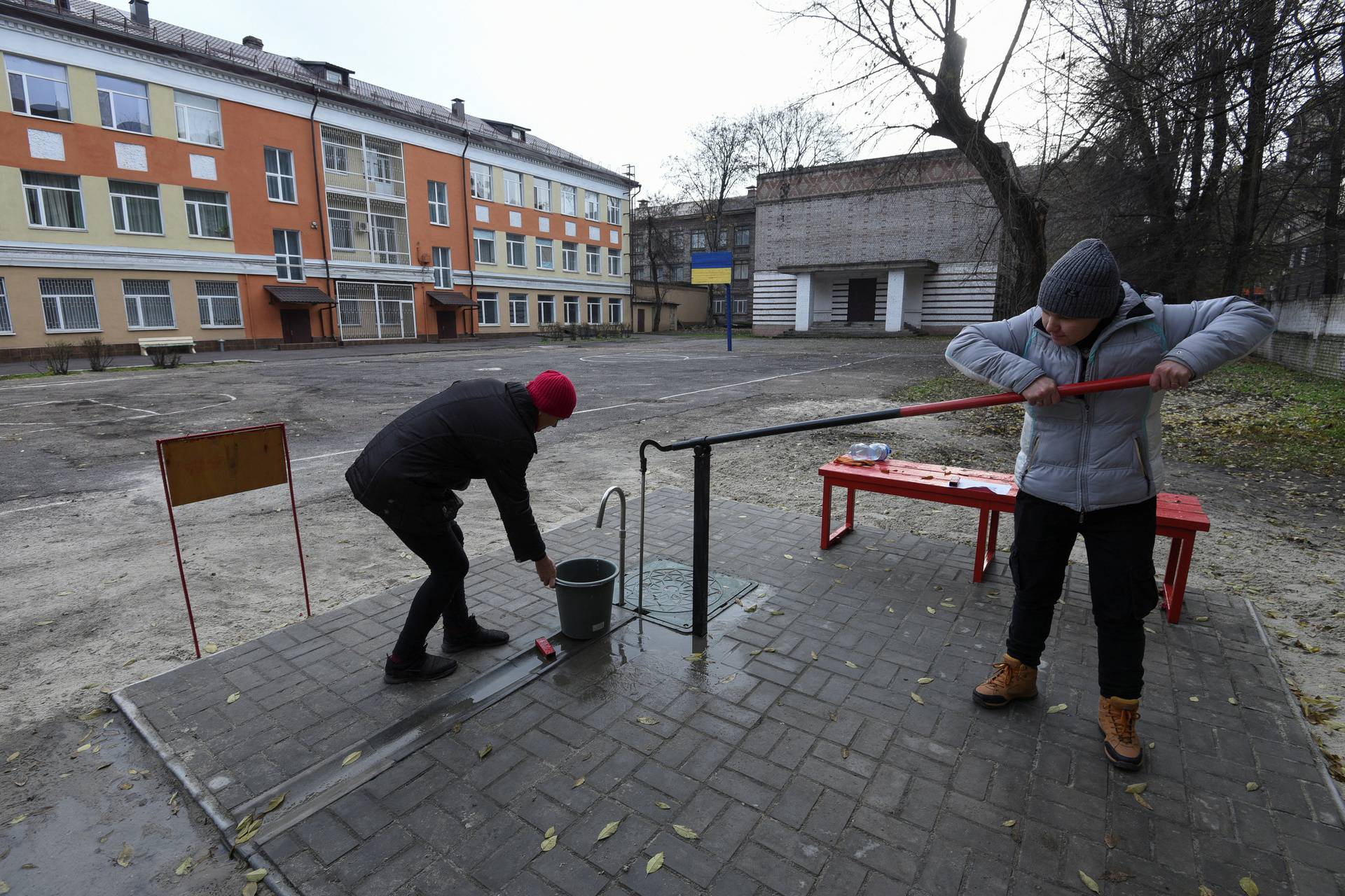 Local residents fill up a bucket with water in Kamianske