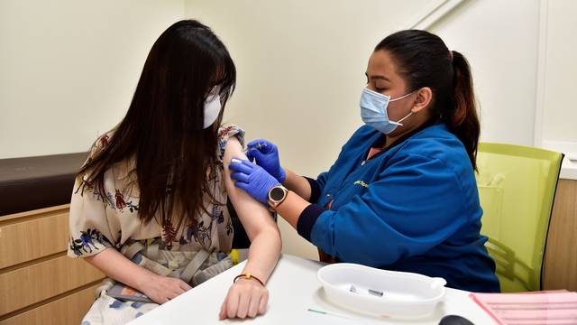 Nurl Anisah, a nurse at StarMed Specialist Centre, administers the Sinovac vaccine to Ms Rachel Liew, 24, in Singapore