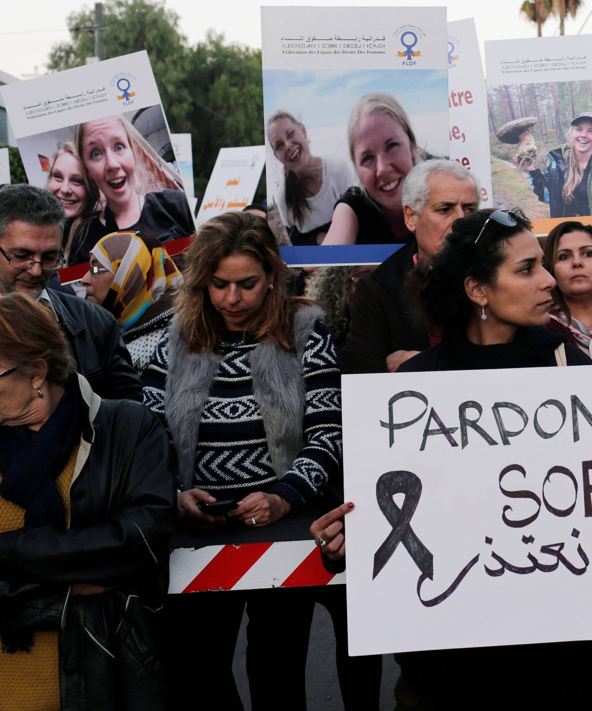 Moroccans gather in front of Denmark's embassy in Rabat to honour Maren Ueland from Norway and Louisa Vesterager Jespersen from Denmark