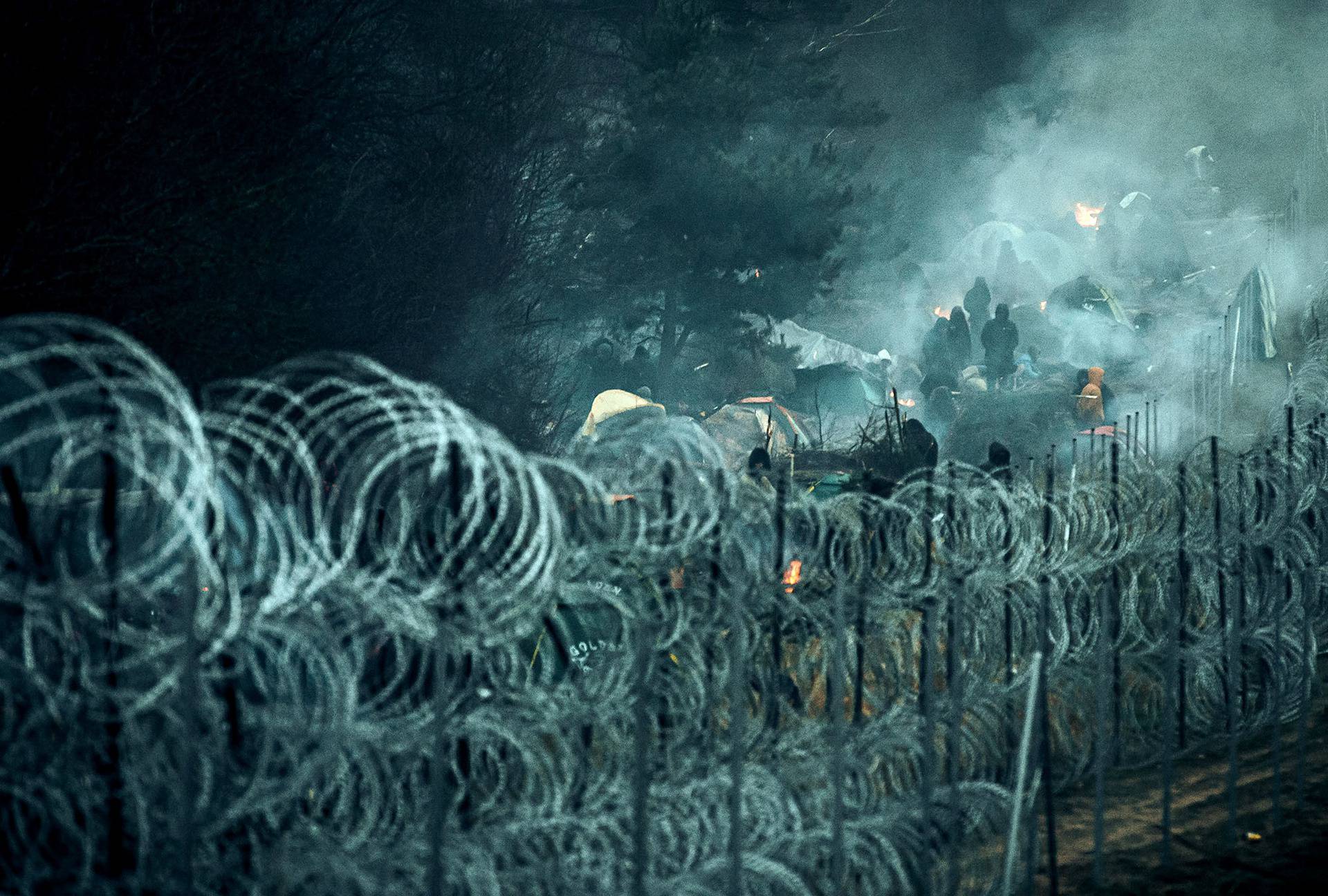 Migrants are seen on the Belarus side of the border with Poland near Kuznica