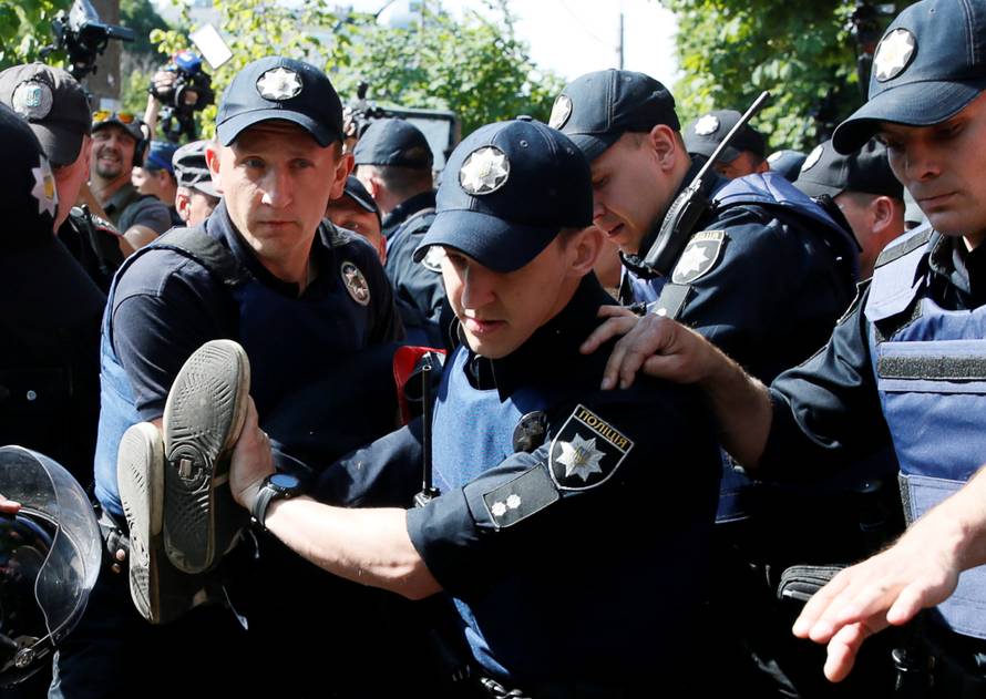 Policemen detain anti-gay protester during Equality March in Kiev