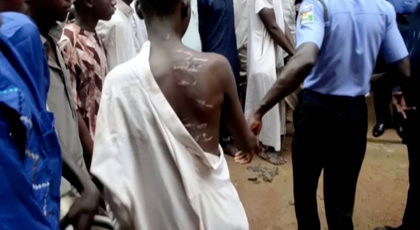 People are pictured after being rescued from a building in the northern city of Kaduna