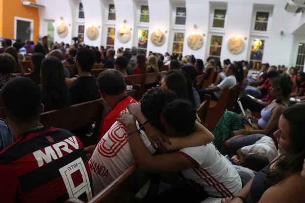 Supporters of Flamengo pray during a mass in memory of the victims of the club