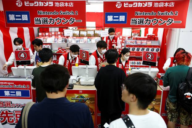 Customers line up to get the Nintendo Switch 2 as the Nintendo starts selling the new consoles globally, in Tokyo