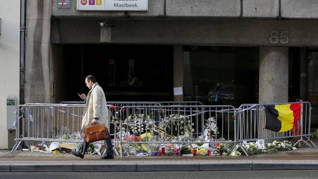 A man walks past a street memorial outside Maelbeek metro station, a week after bomb attacks took place in the metro and at the Belgian international airport of Zaventem, in Brussels, Belgium