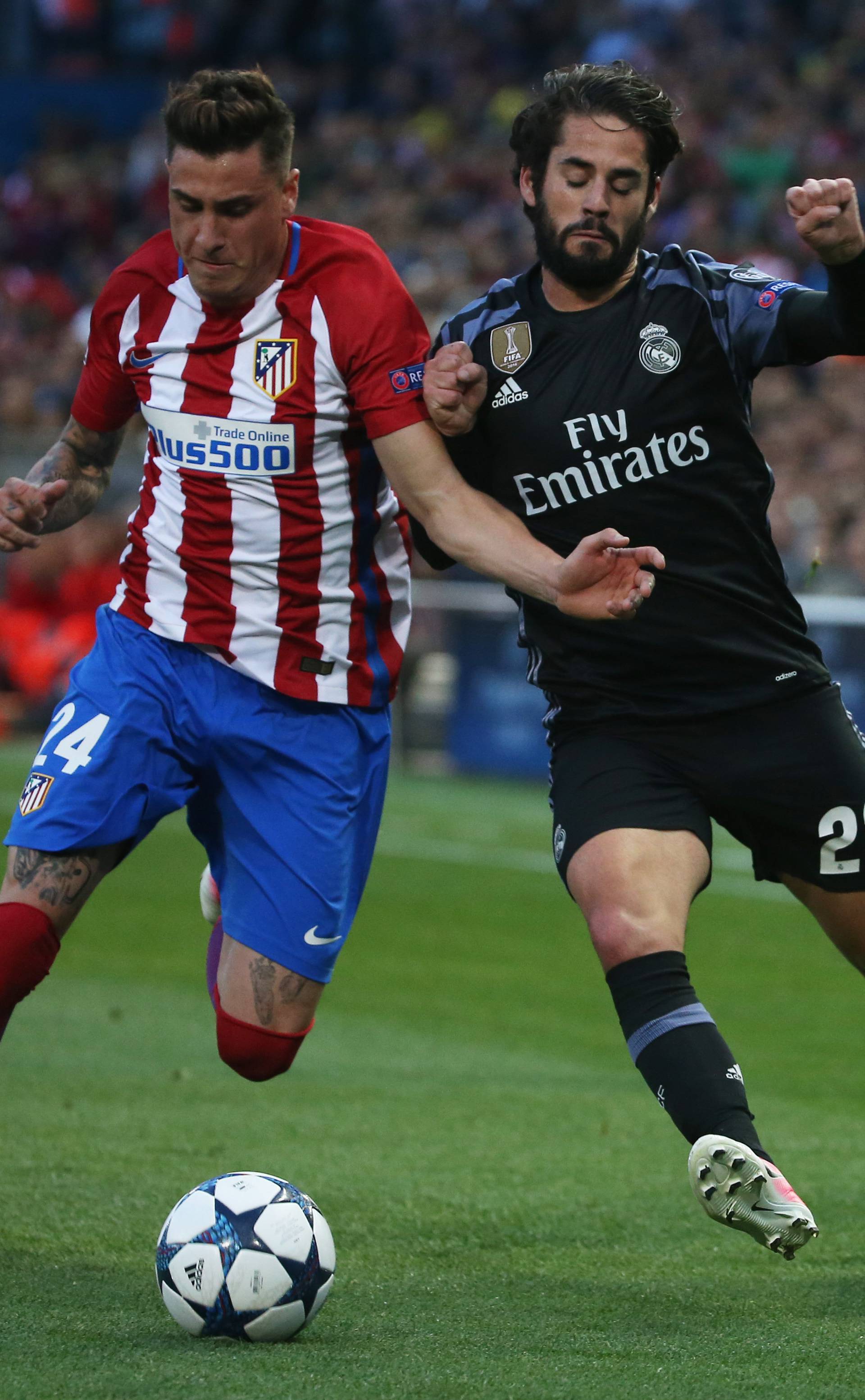 Atletico Madrid's Jose Gimenez in action with Real Madrid's Isco