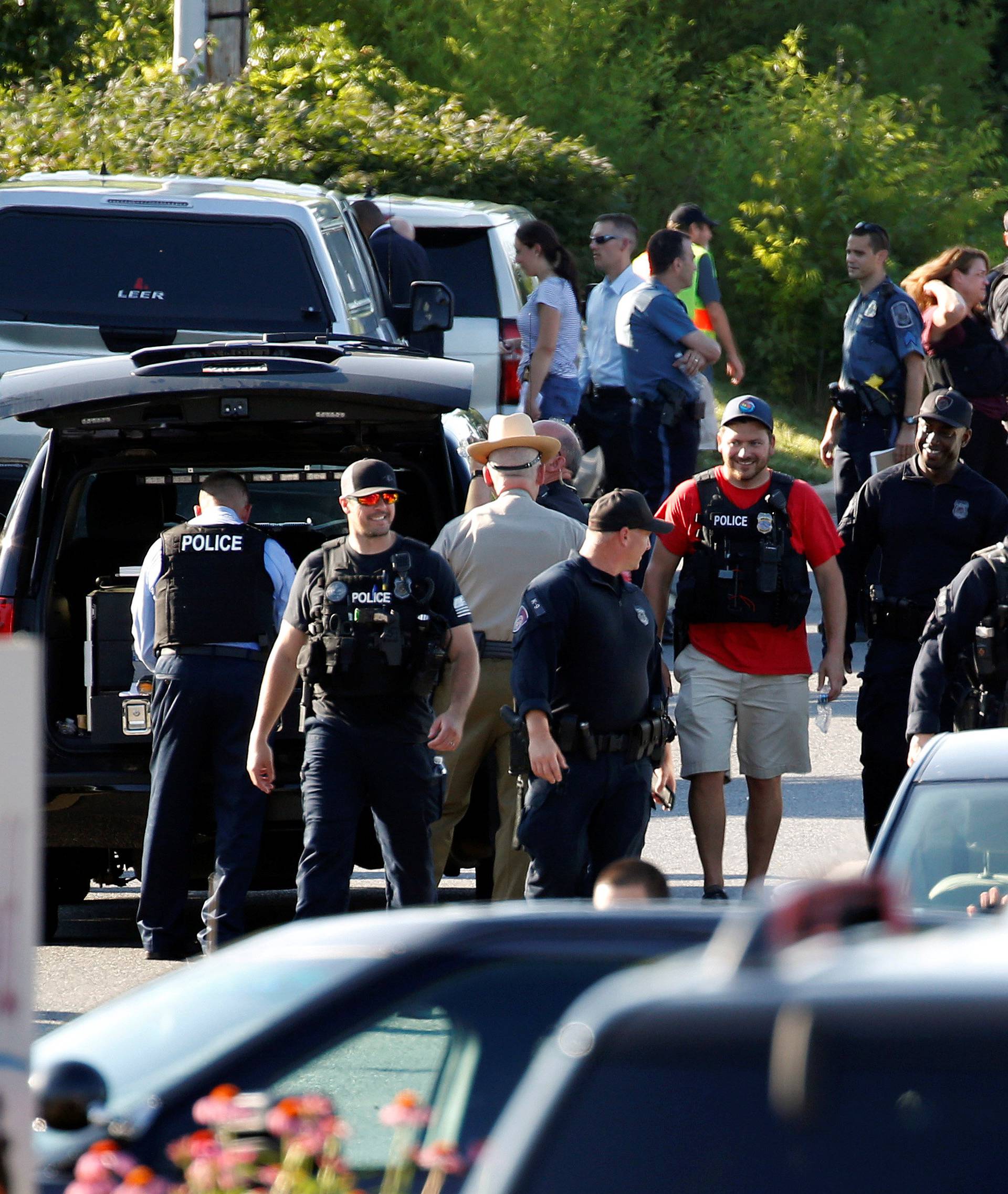 Police walk near a shooting scene at the Capital Gazette newspaper in Annapolis