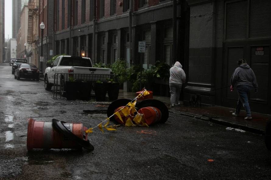 Women walk in the rain as Hurricane Ida makes landfall in Louisiana, in New Orleans