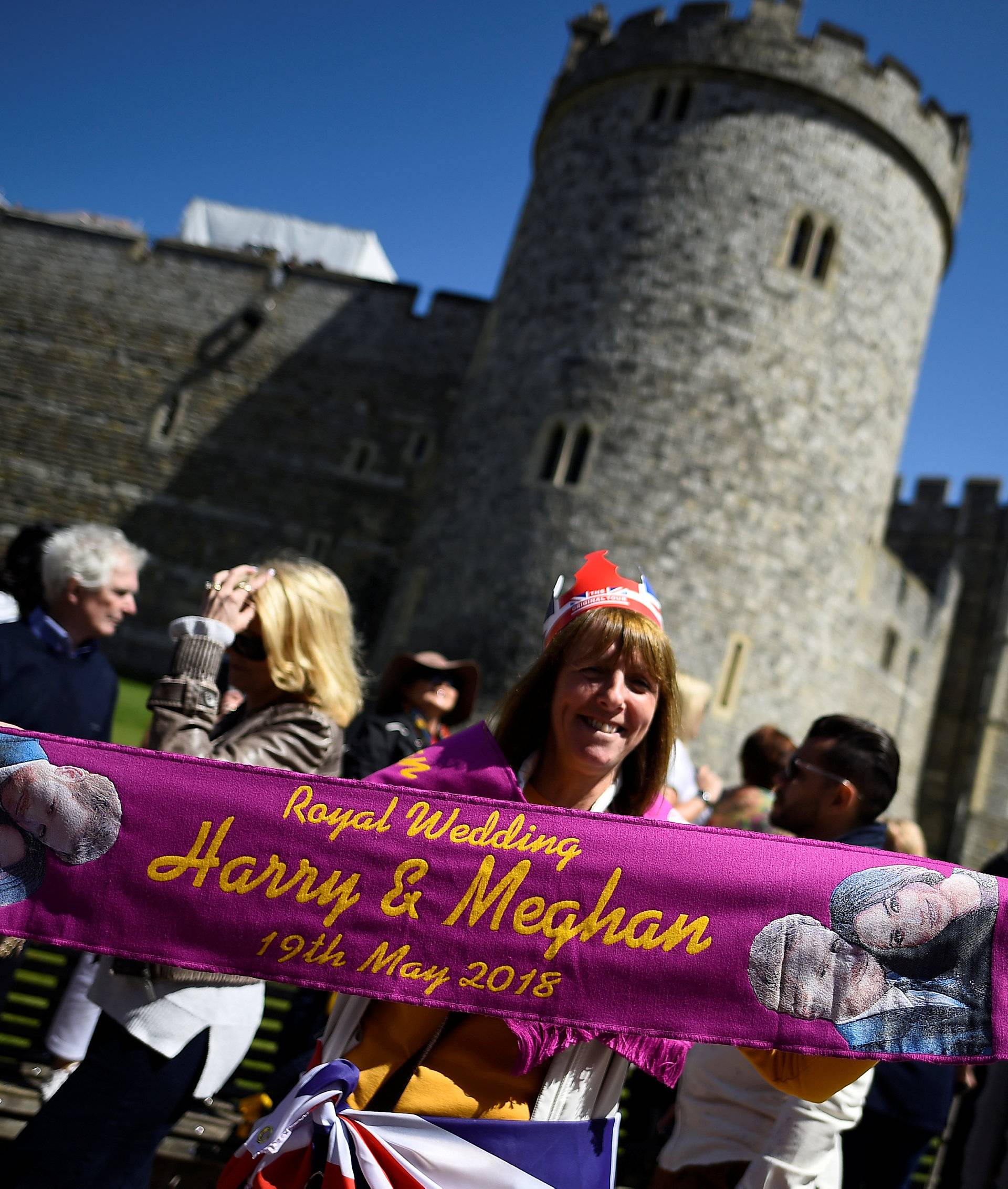 A woman holds up a commemorative scarf during rehearsals for the wedding of Britain's Prince Harry and Meghan Markle in Windsor