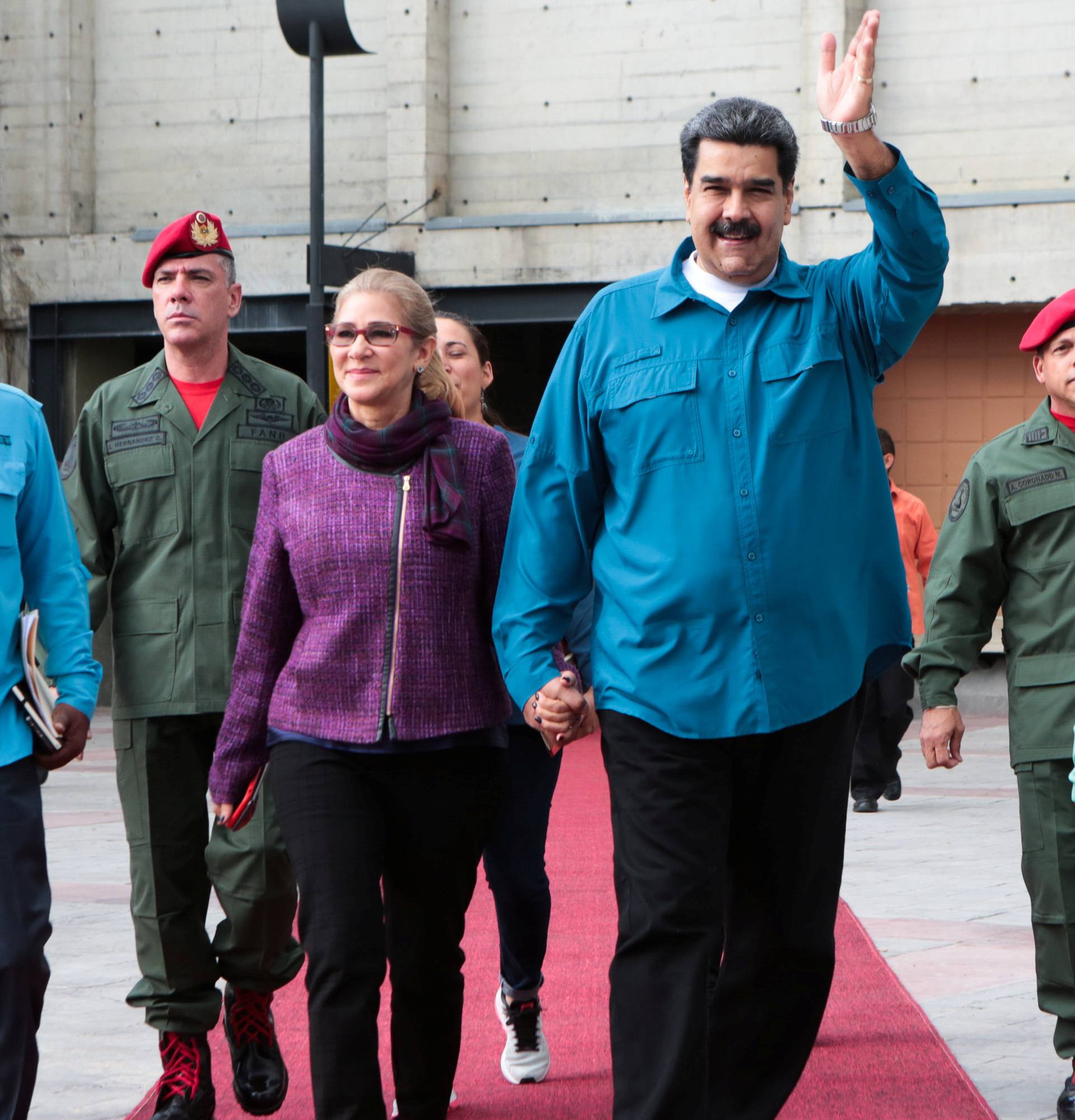 Venezuela's President Nicolas Maduro and his wife Cilia Flores, attend a meeting with supporters in Caracas