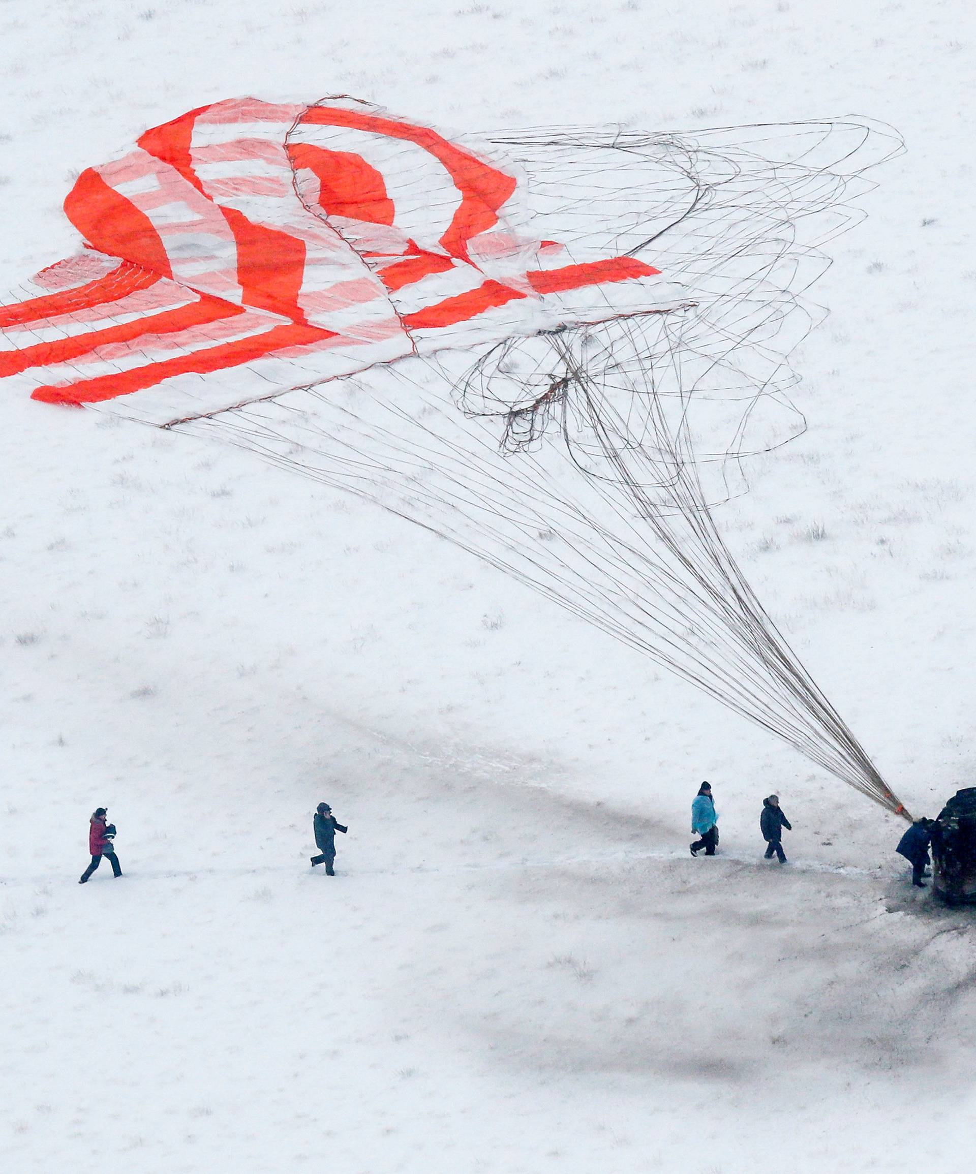 Search and rescue team approaches the Soyuz MS-09 capsule carrying the International Space Station crew after landing near Zhezkazgan