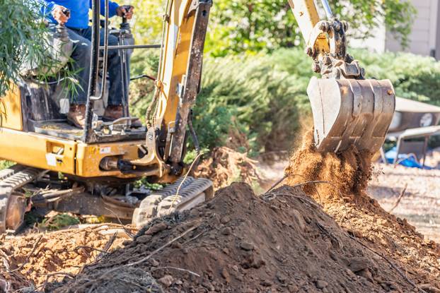 Working Excavator Tractor Digging A Trench At Construction Site.