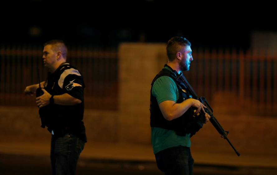 Las Vegas Metro Police officers work near the concert venue after a mass shooting at a music festival on the Las Vegas Strip in Las Vegas
