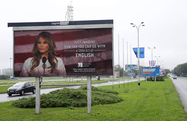 Cars drive near a billboard advertising a language school with the image of U.S. first lady Melania Trump in Zagreb, Croatia