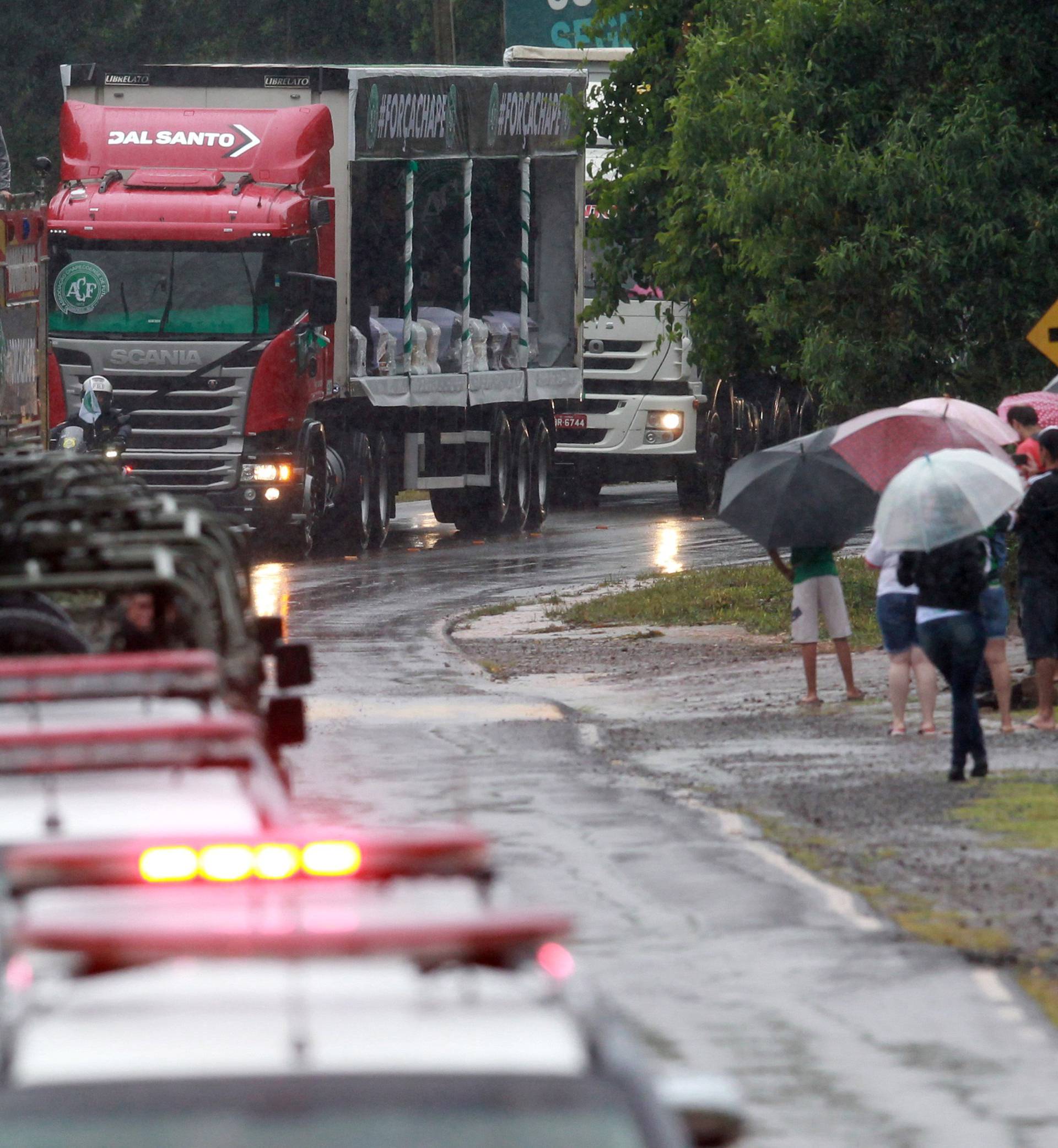 Trucks carry  the coffins of victims of the plane crash in Colombia on their way to the Arena Conda stadium in Chapeco