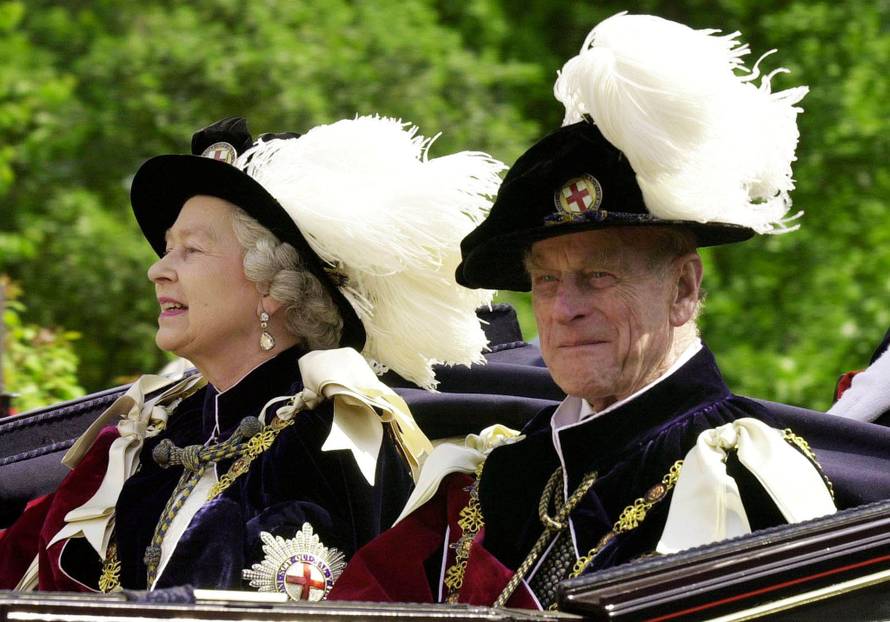 FILE PHOTO -  File photo of Britain's Queen Elizabeth II and Prince Phillip, the Duke of Edinburgh, riding in an open-topped carriage to Windsor Castle