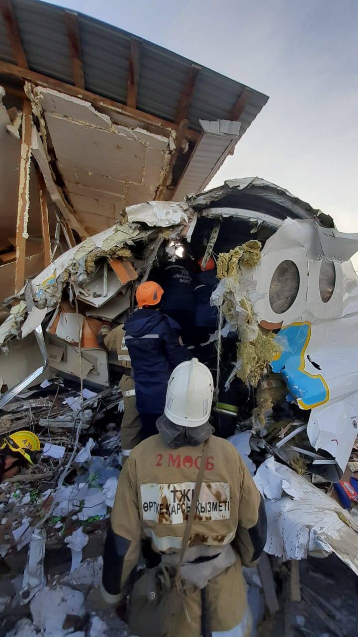 Emergency personnel work at the site of the plane crash near Almaty