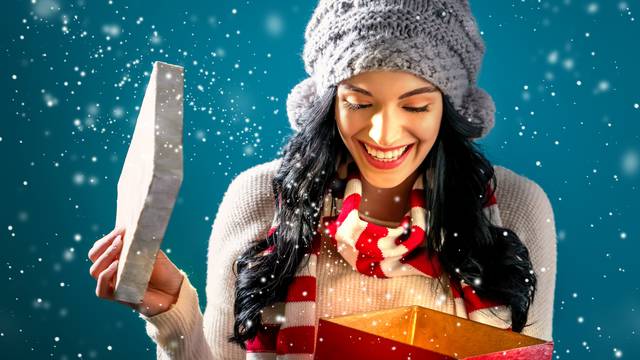 Happy young woman with Christmas present box