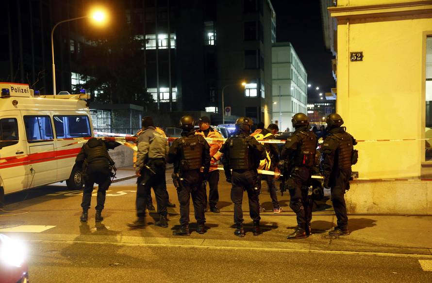 Police stand outside an Islamic center in central Zurich