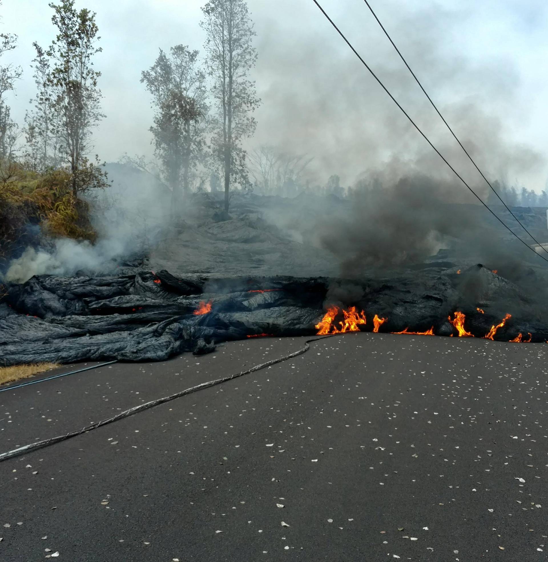 A lava flow is seen on a road in Pahoa