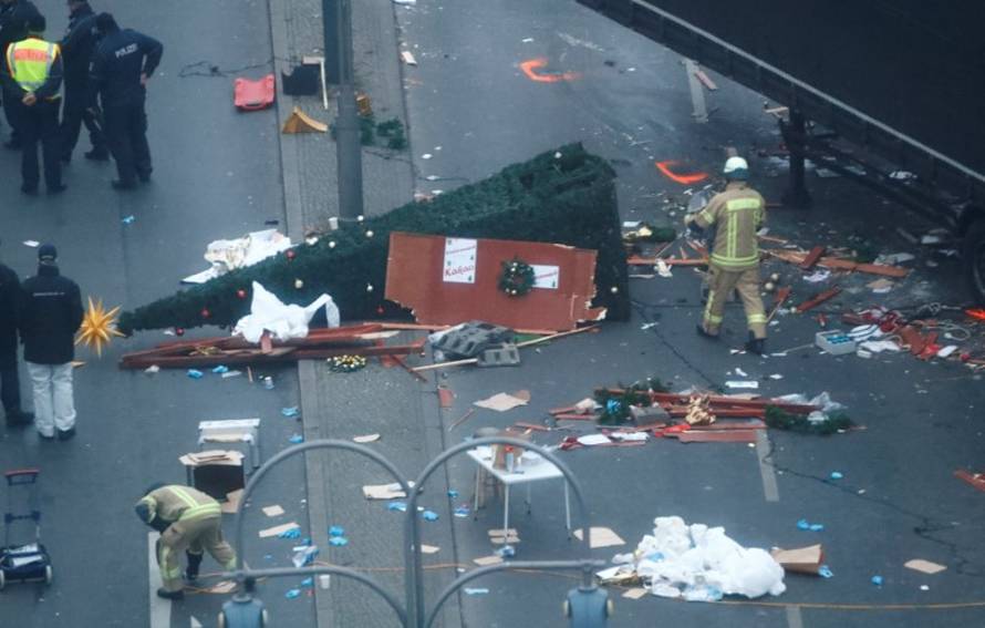 Rescue workers are seen at the scene where a truck ploughed through a crowd at a Christmas market on Breitscheidplatz square in Berlin
