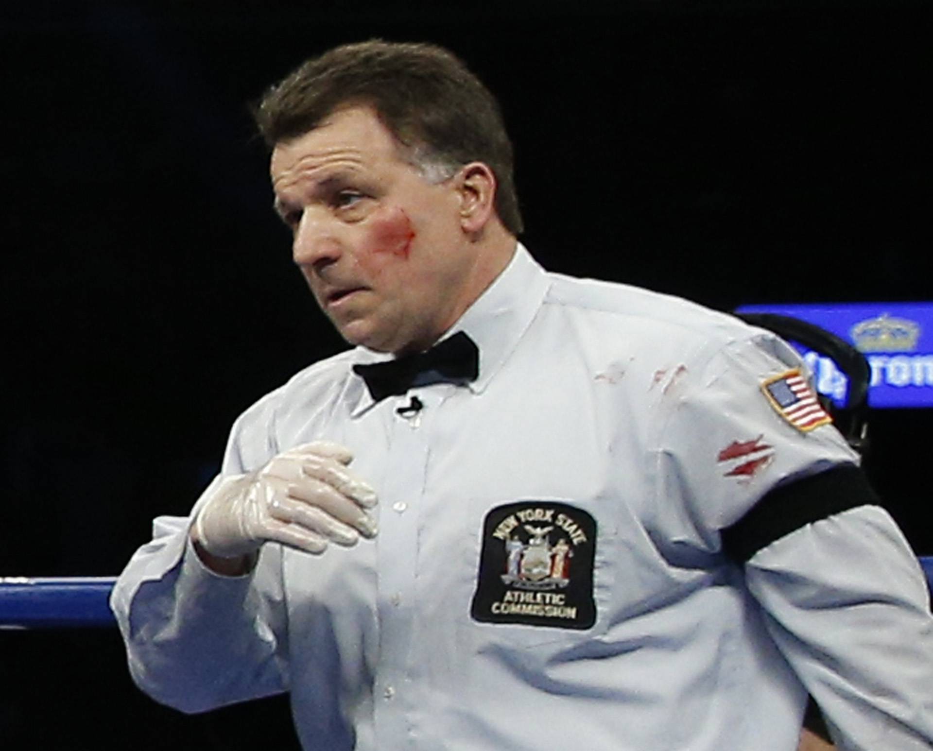 Referee Arthur Mercante Jr has blood on his cheek and shirt  after being hit by Badou Jack