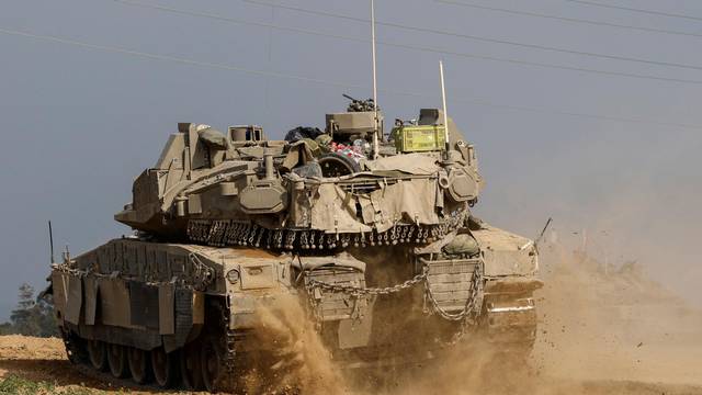 An Israeli APC re-enters Israel from Gaza, near the Israel-Gaza border, in southern Israel