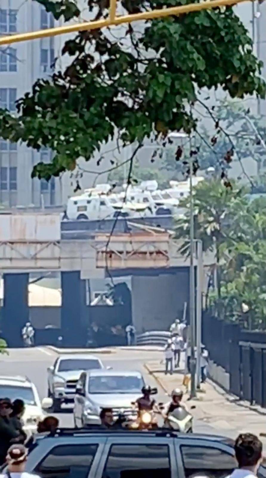 National Guard vehicles are seen on a freeway bridge during a protest in Caracas