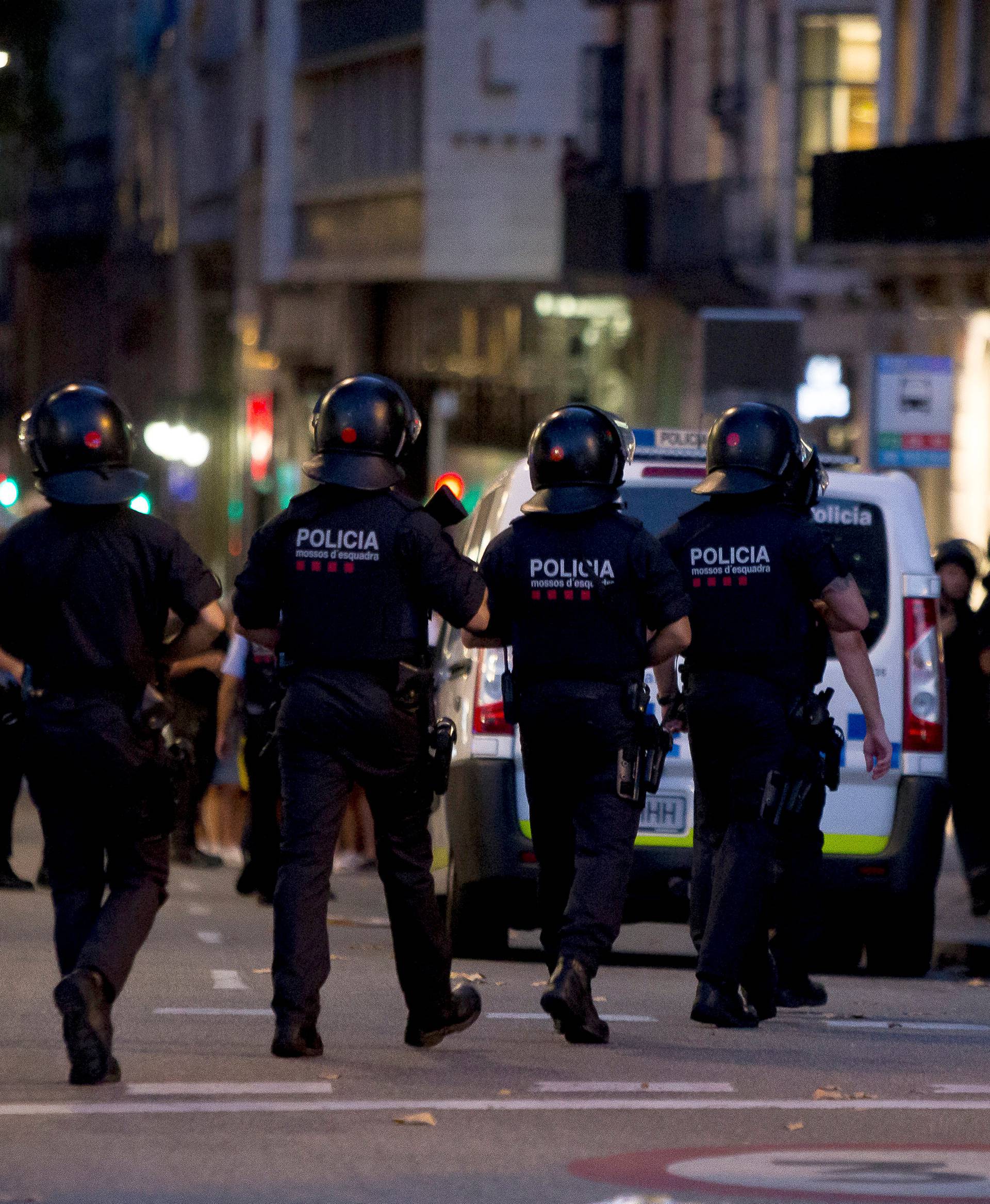 Police patrol the area after a van crashed into pedestrians near the Las Ramblas avenue in central Barcelona