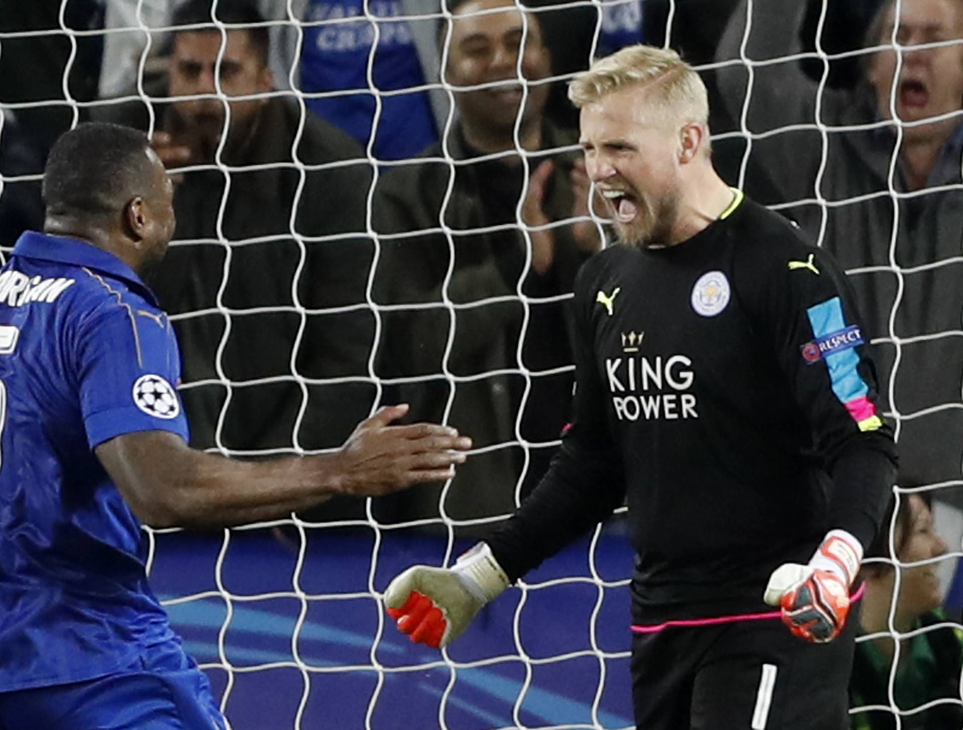 Leicester City's Kasper Schmeichel celebrates with Wes Morgan after saving a penalty