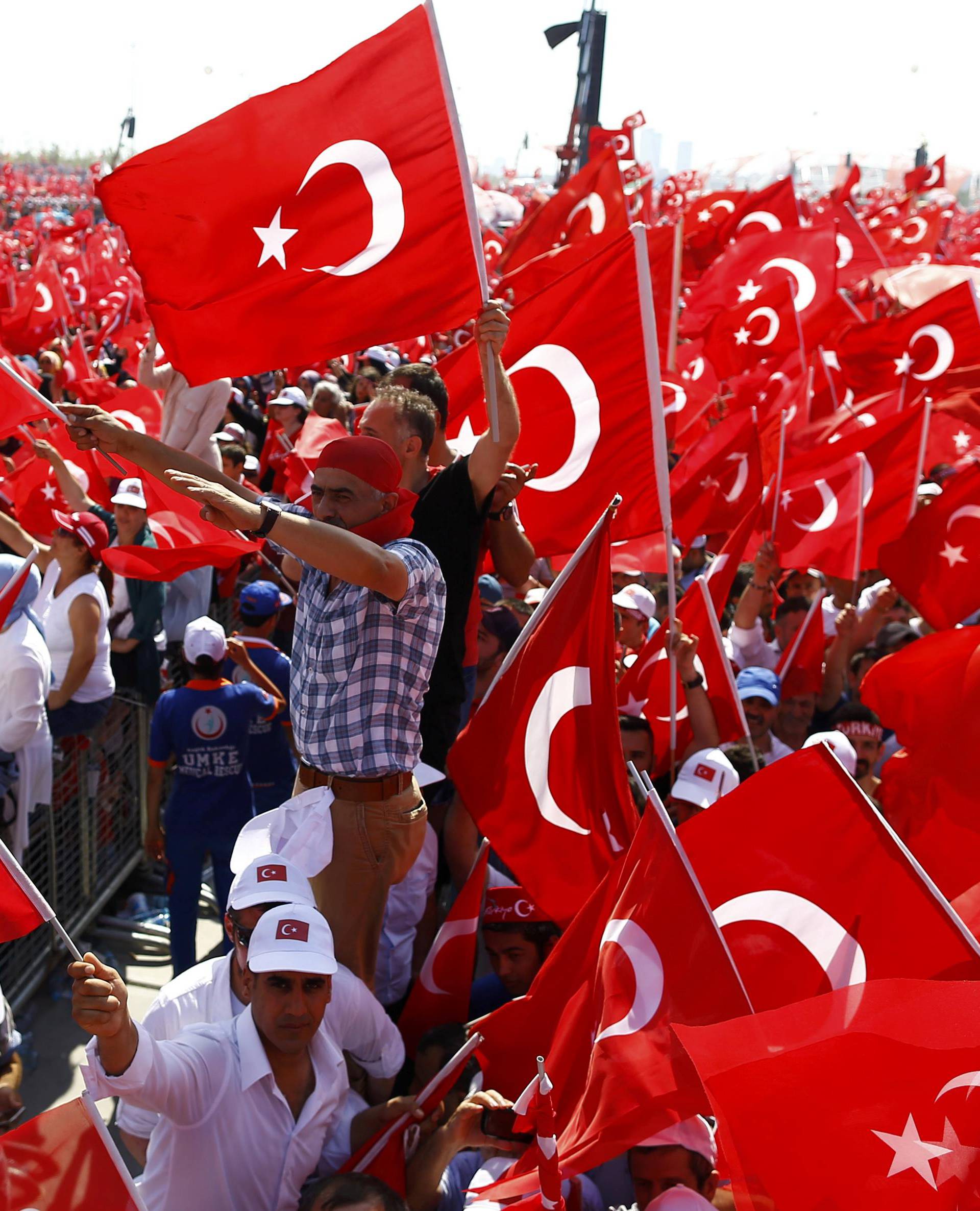 People wave Turkey's national flags during the Democracy and Martyrs Rally in Istanbul
