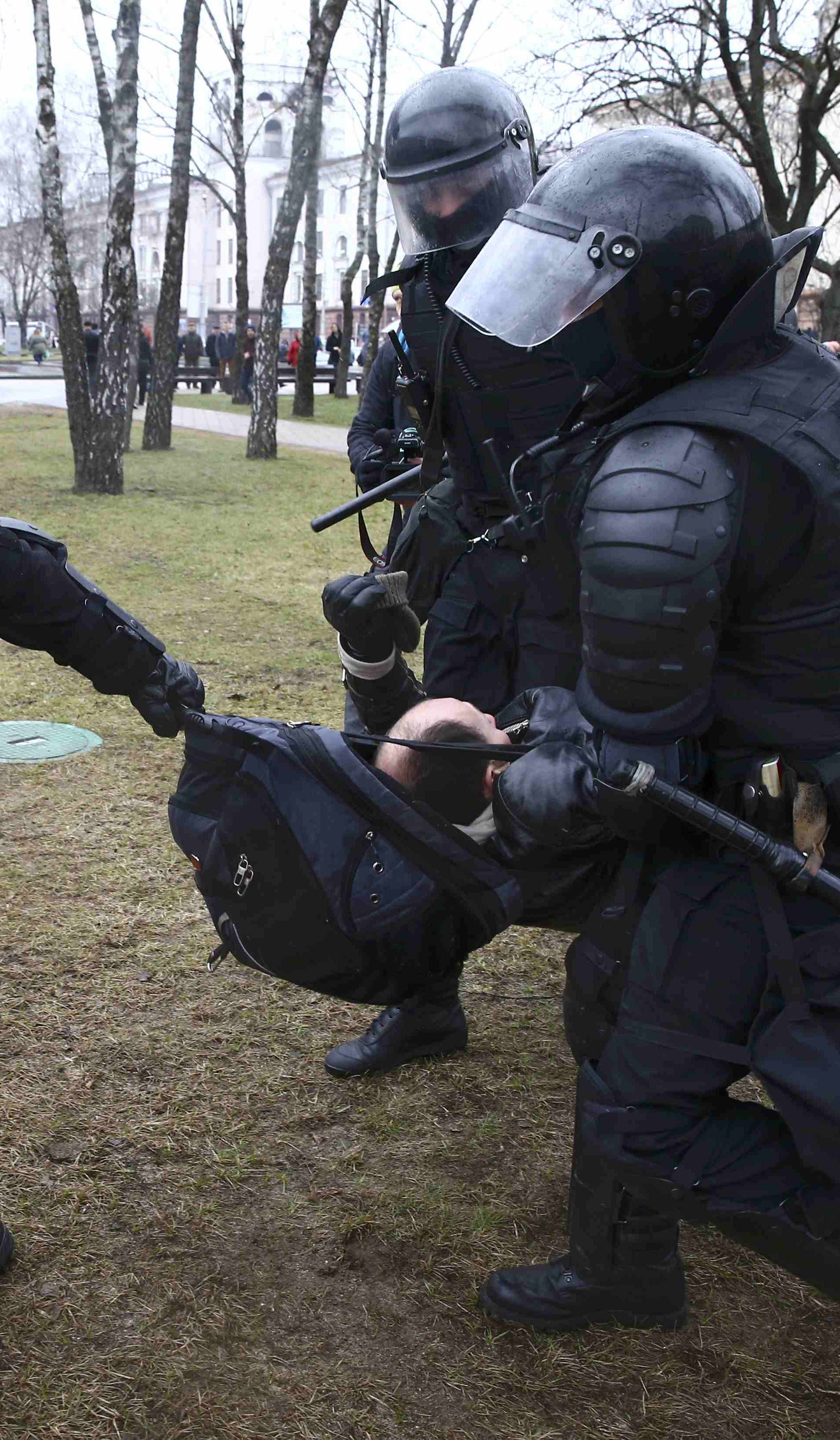 Law enforcement officers detain a participant of a rally marking the anniversary of the proclamation of the Belarussian People's Republic in Minsk