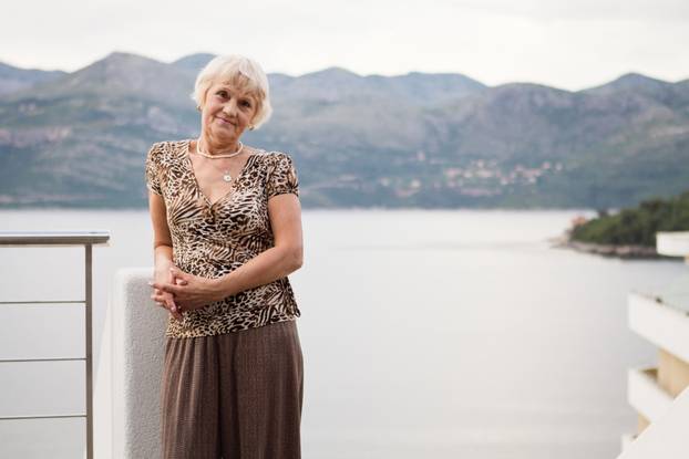 Senior Woman Relaxing by the sea on the seashore