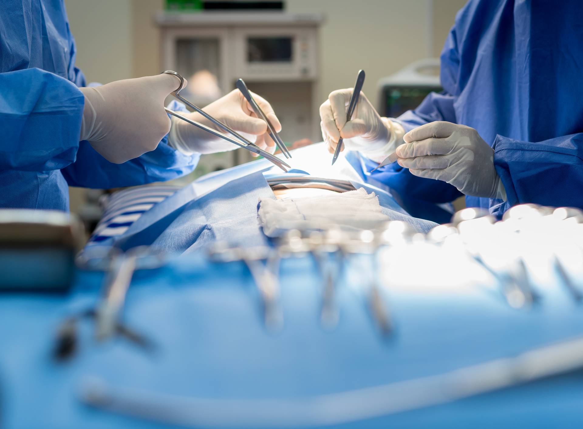 Asian doctor and an assistant in the operating room for surgical venous vascular surgery clinic in hospital.