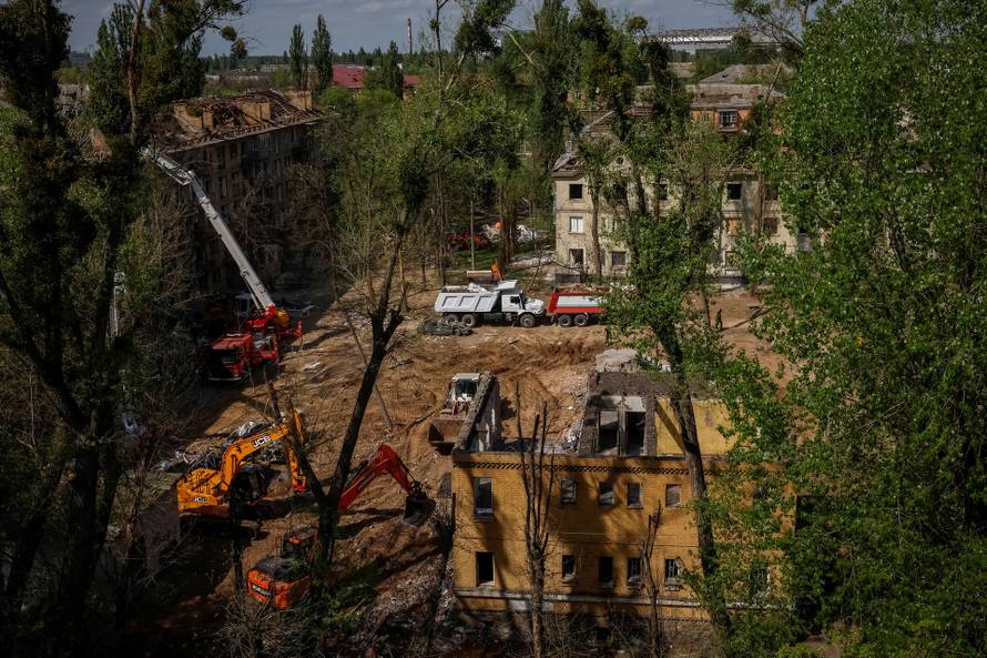 People mourn at the site of a Russian missile strike on a residential area, in Kyiv