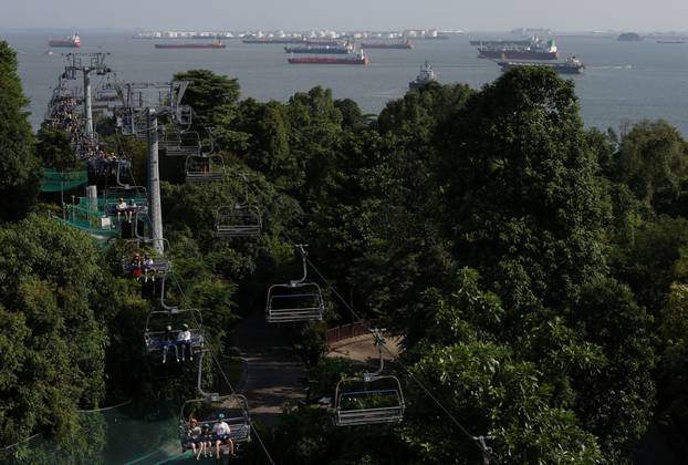People ride on chairlifts in Sentosa Island, Singapore