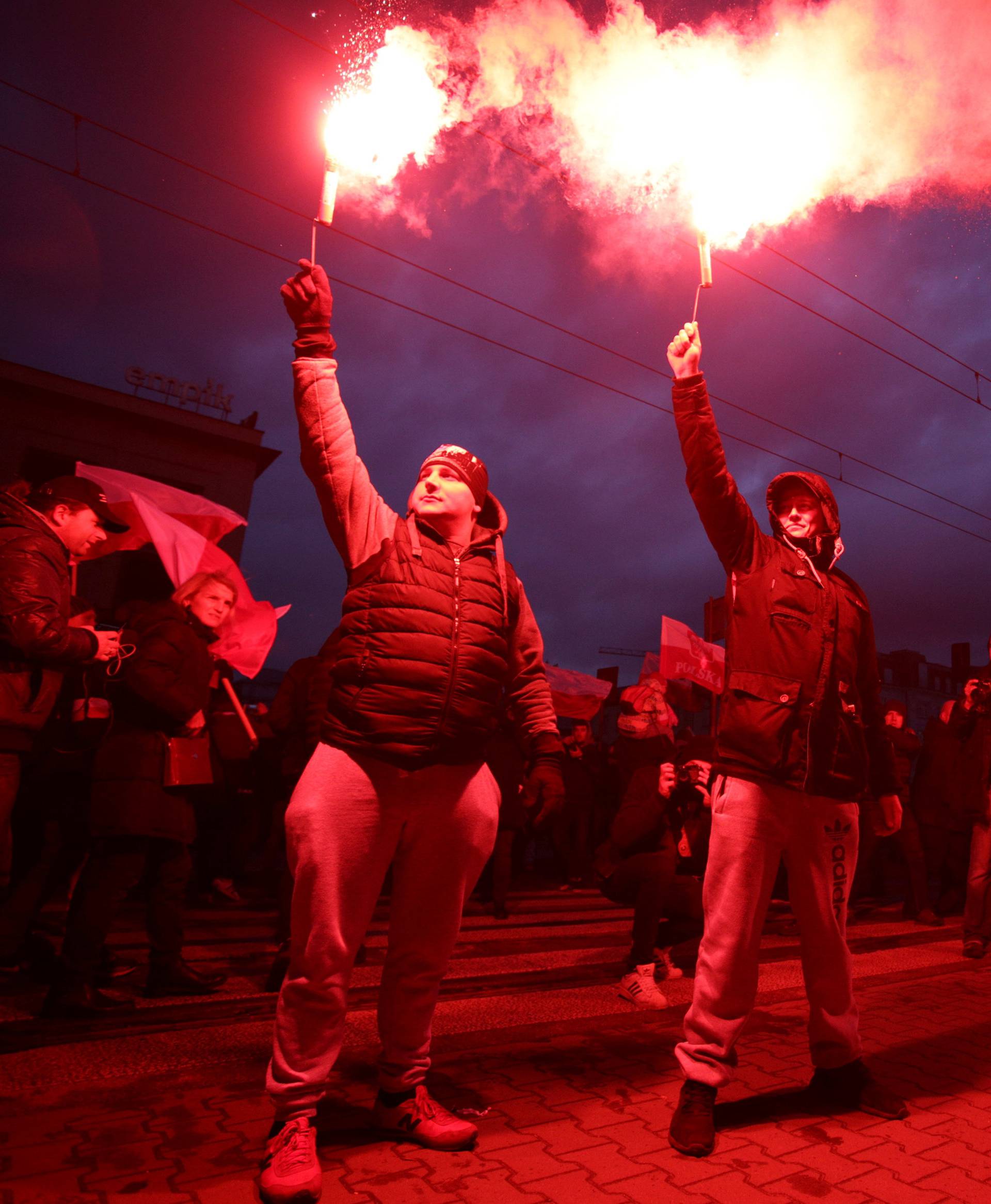 Protesters light flares and carry Polish flags during a rally, organised by far-right, nationalist groups, to mark 99th anniversary of Polish independence in Warsaw