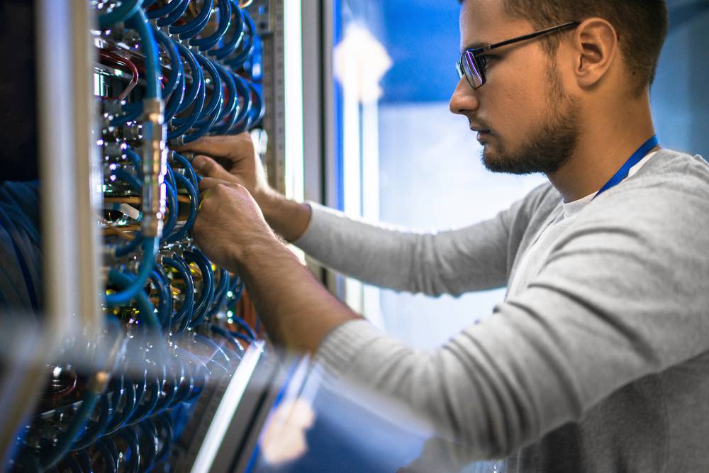 Side,View,Portrait,Of,Young,Man,Wearing,Glasses,Connecting,Cables