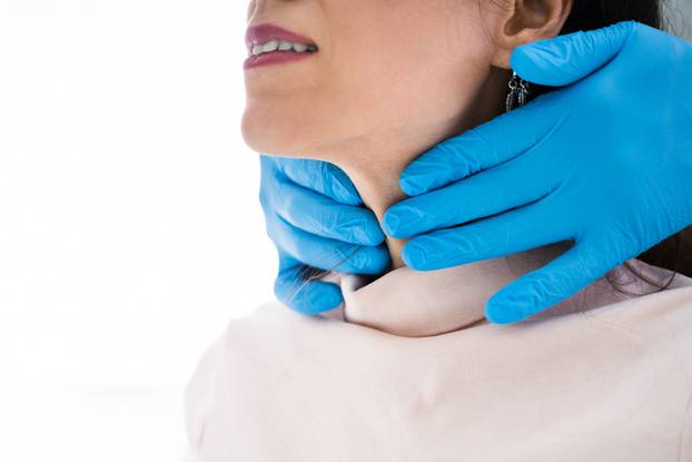 Doctor Checking Thyroid Of A Young Woman