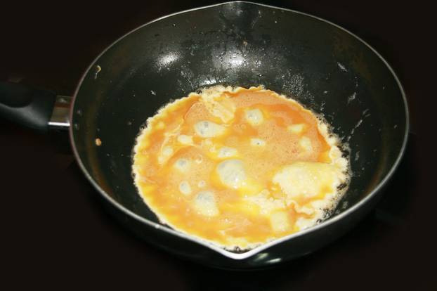 cooking omelette in the pan