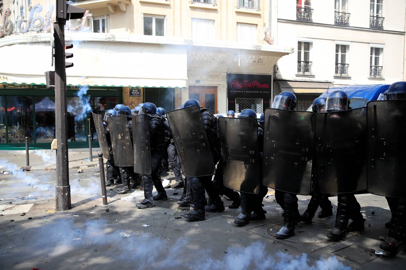 French riot police secure a position during clashes before the start of the traditional May Day labour union march in Paris