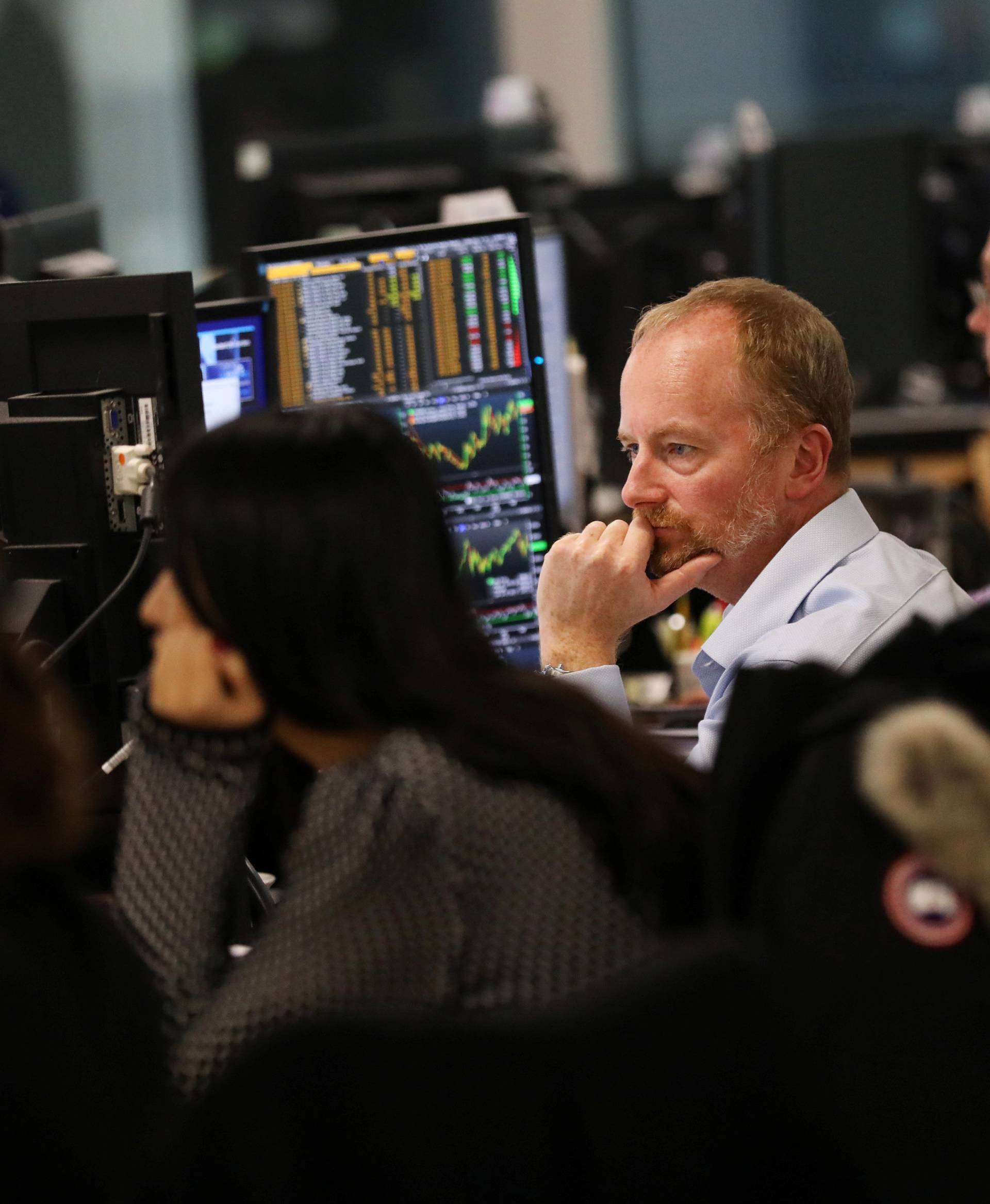 Investment managers, in the office of Aberdeen Standard Investments, watch Britain's Prime Minister, Theresa May, deliver a statement to the House of Commons, in London