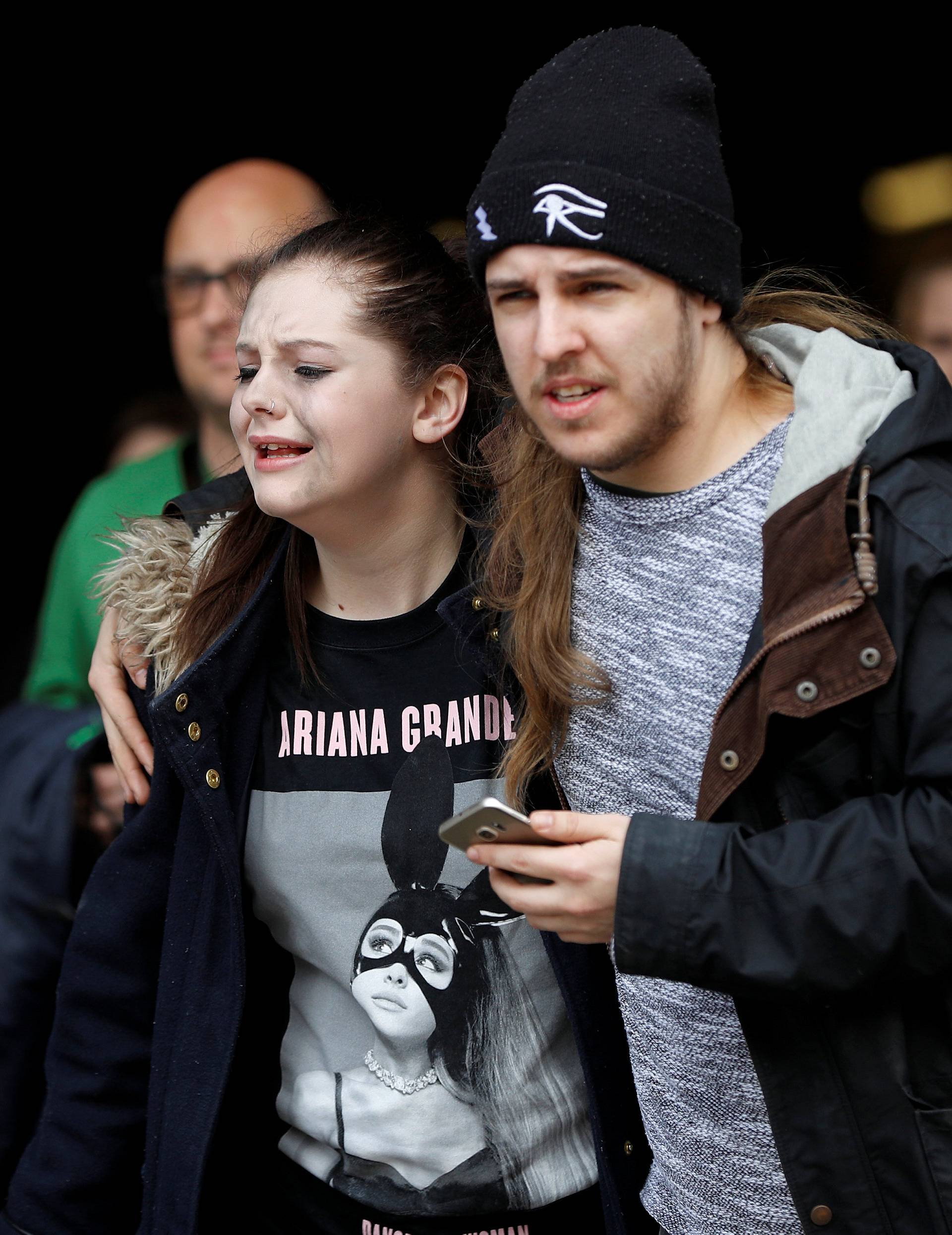 People rush out of the Arndale shopping centre as it is evacuated in Manchester